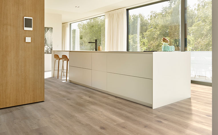 luxury vinyl plank flooring in kitchen with large white kitchen island