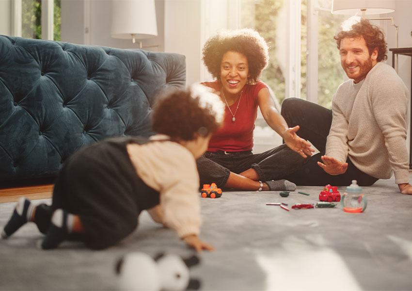 family playing on carpet in living room