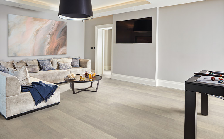 hardwood flooring in basement living room with game table